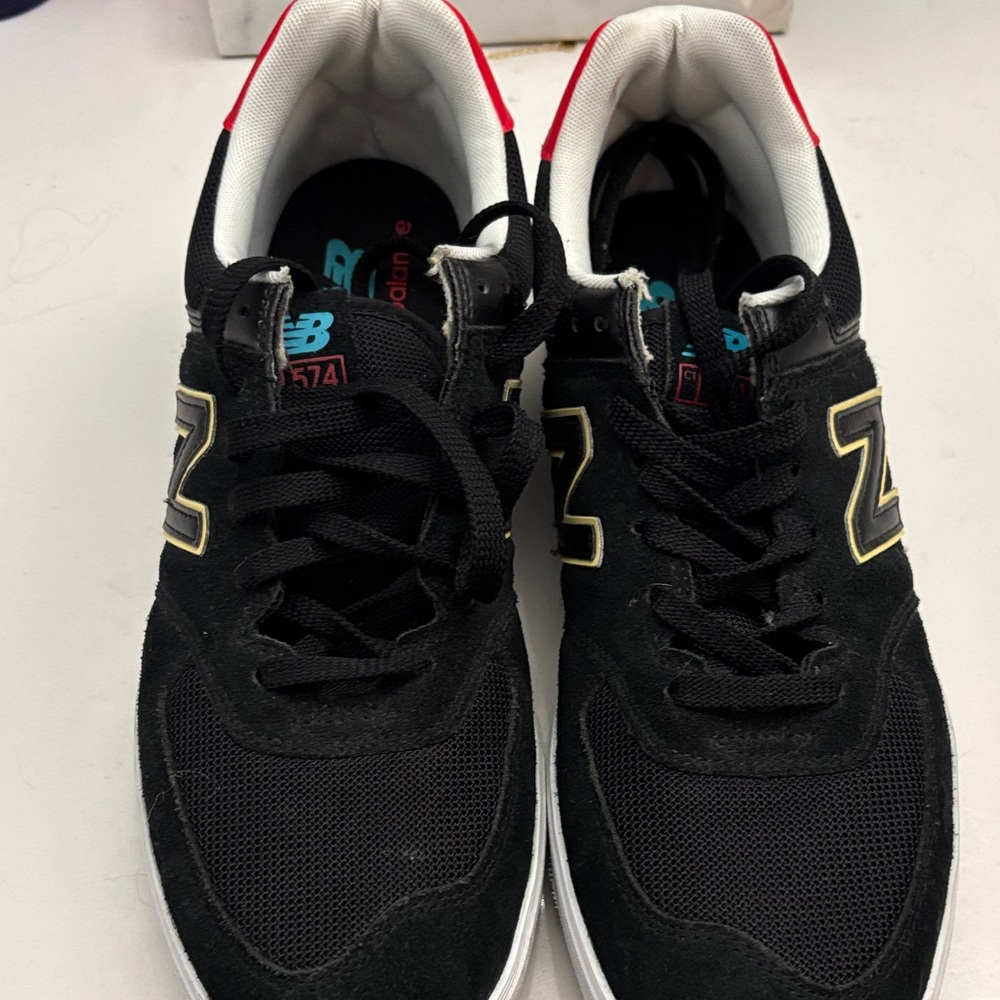 New Balance Black Sneakers with Gold Accents